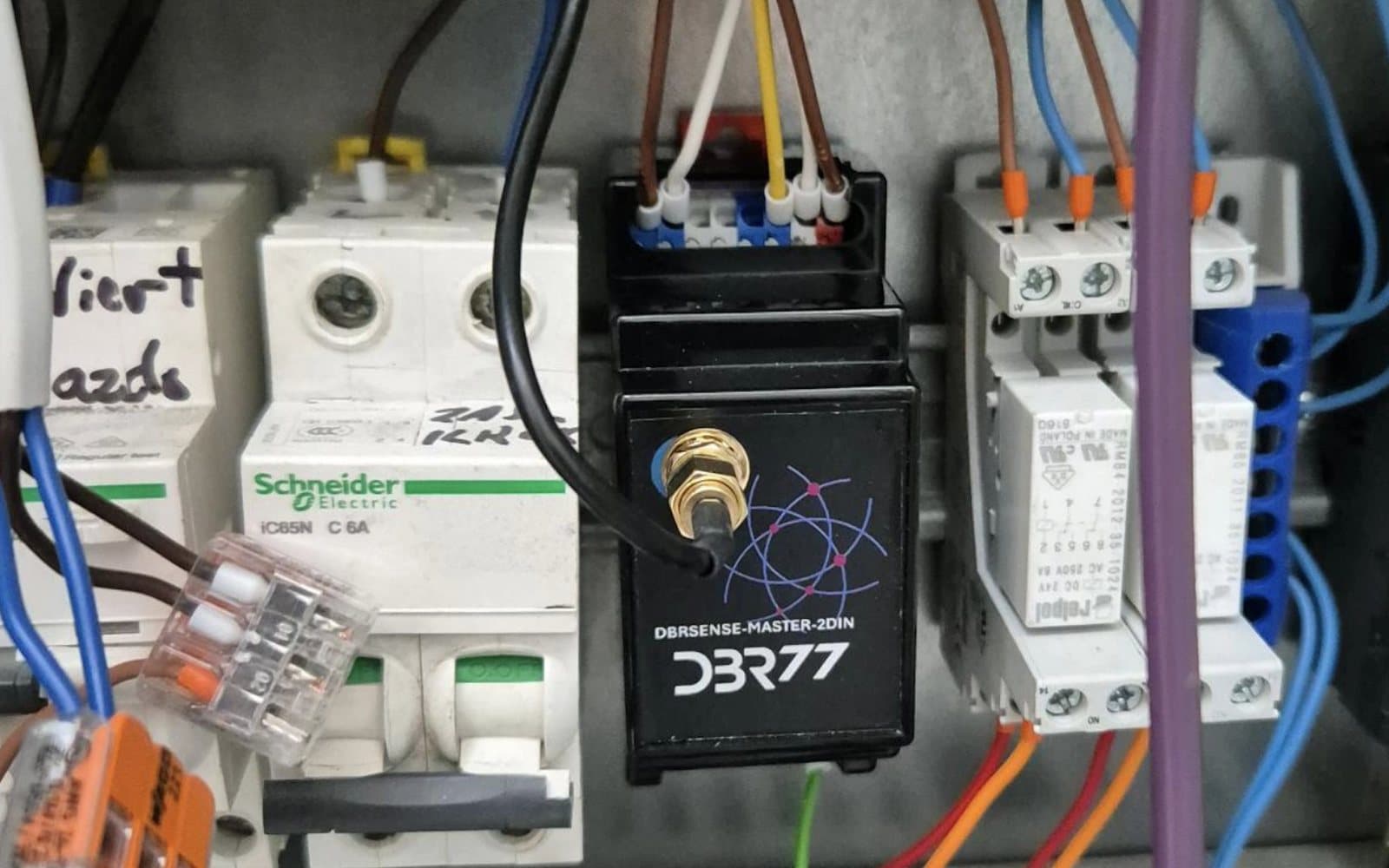 DBR77 MasterHub gateway on a DIN rail in an electrical cabinet