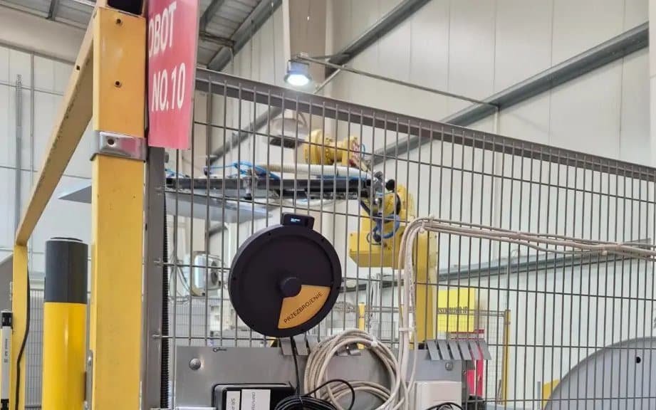 DBR77 Status Deck at a production workstation behind a guard fence